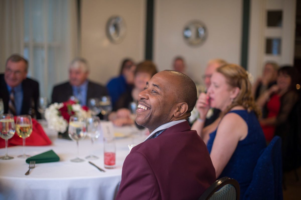 guests smiling as they listen to groom speech