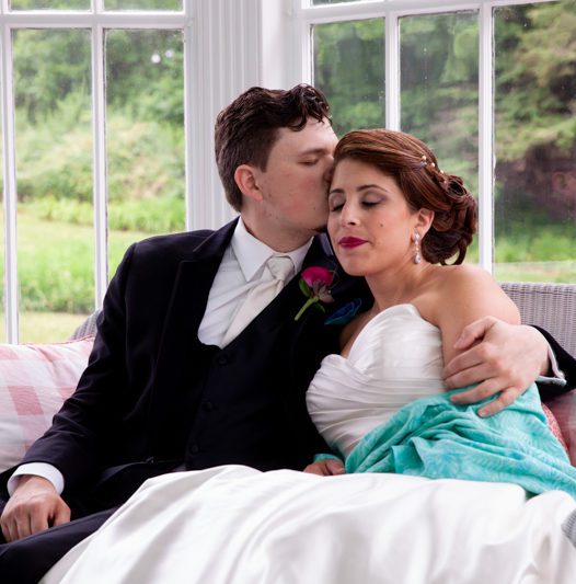 cuban-flair-wedding-robert-rachel-sitting-together-on-glass-in-porch